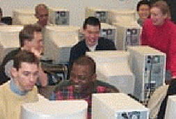 Smiling students at computer terminals